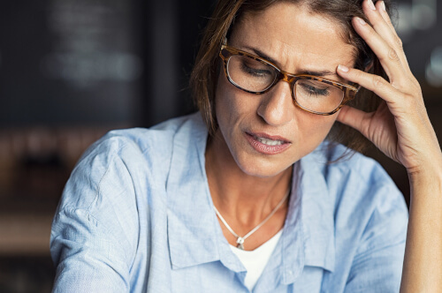 stressed woman holding head